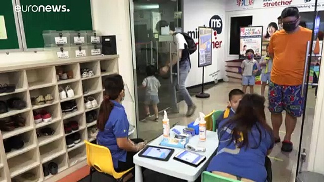 Pupils wearing face masks return to school in Singapore