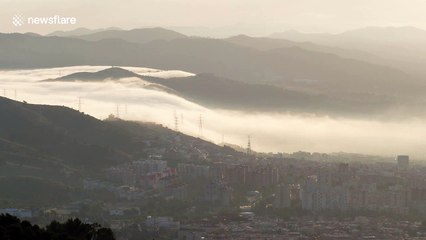 Watch this amazing cloud fall in Barcelona city as fog rolls in from the mountains