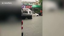 Vehicles trapped on Thai road submerged by deep floodwater