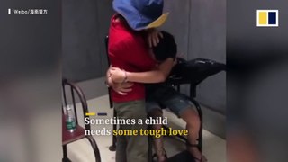 Suspect cries in police station, hugging his mother