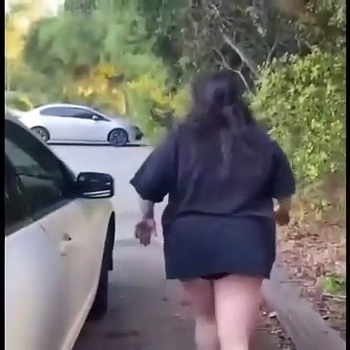 Apenas uma mulher a tentar mudar os tampos de roda do seu carro por uns novos
