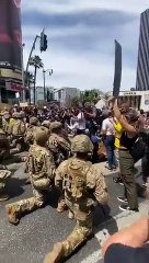 AMERICAN ARMED FORCES KNEEL THE CROWD IN PEACE GESTURE
