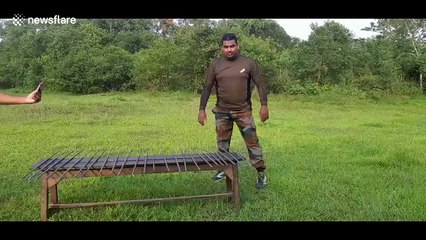 Indian dubbed 'hammerhead man' bends 24 iron bars over his head in world record attempt