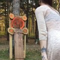 Girl Throws Knife Through Rubber Band and Pins it on Target Board