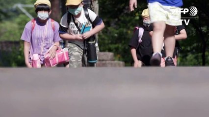 Japanese students go back to school, with face shields