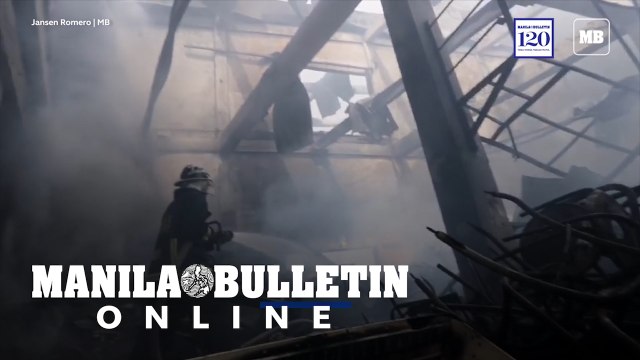 Fire fighters extinguishing the remaining fire that razed three warehouse at Potrero, Malabon City