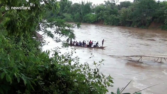 Terrifying moment Indian boatman plunges into flooded river but manages to swim to safety