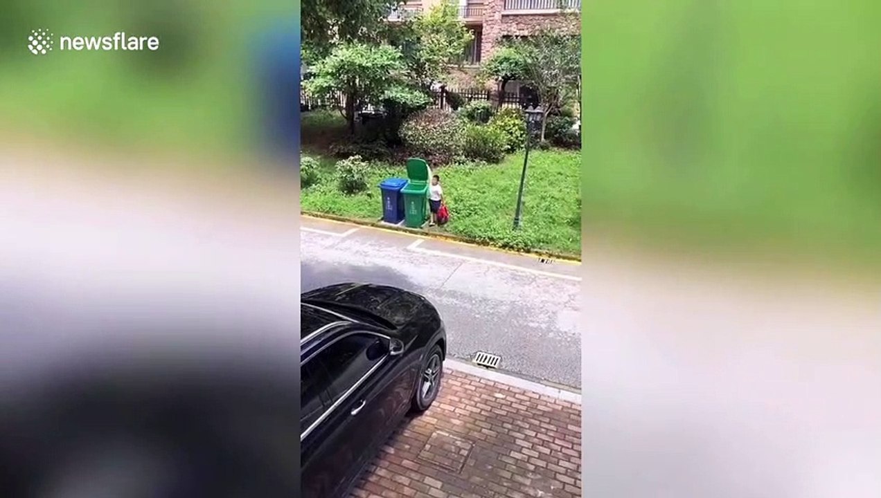 Chinese boy throws rubbish into bin in the most nonchalant way