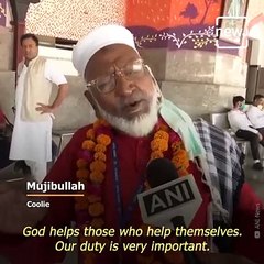 This 80-year-old coolie is helping migrant workers carry their luggage free of cost .