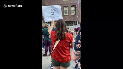 Black Lives Matter activists chant in front of Minneapolis police station