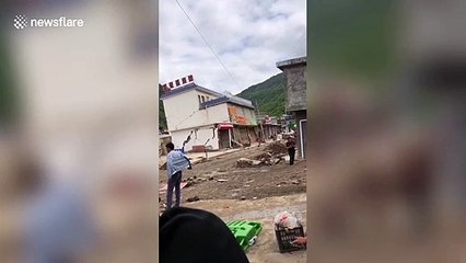 Hotel collapses into flooded river in southern China after rainstorm