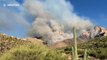 Incredible footage of wide-bodied DC-10 tanker flying extremely low over the Catalina Mountain range to extinguish wildfire