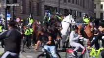 Police escort injured man who was attacked by 'Black Lives Matter' protesters in London