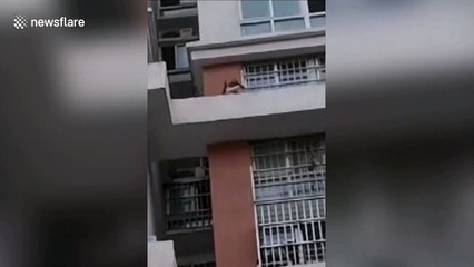 Chinese men risk their lives to rescue four-year-old trapped on 14th-floor building ledge
