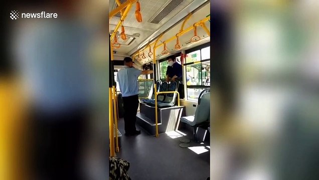 Chinese woman climbs into bus through window after being refused entry without scanning health QR code