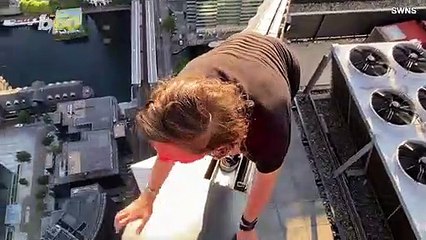 Daredevil Teen Casually Hangs One-Handed Off the Side of Building