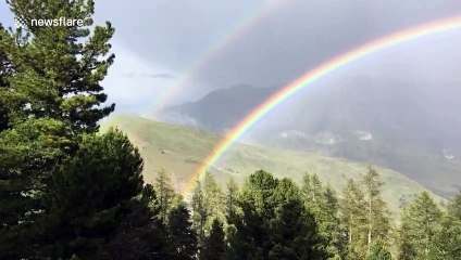 Beautiful footage of a double rainbow appearing over French Alps