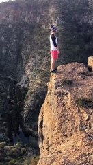 daredevil backflip on the edge of a cliff