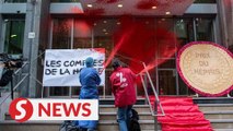 Activists douse French health ministry in red paint