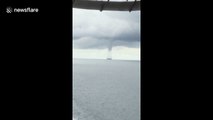 Large tornado passes between ships in Indonesia