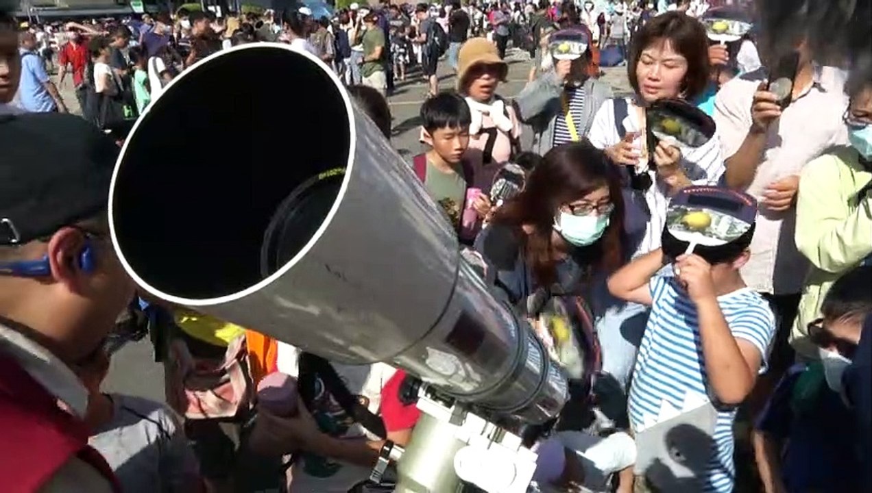 Excited Taiwanese watch partial solar eclipse