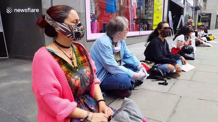 Extinction Rebellion protesters picket reopening clothing stores in London