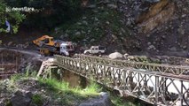 Moment truck plummets into gorge after bridge buckles under its weight in northern India