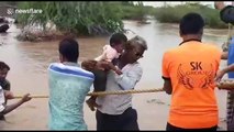 Western Indian villagers create human chain to rescue residents in flood