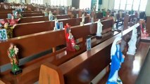 Church in the Philippines uses religious statues on benches to replace parishioners