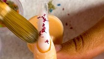 The 'milk bath' nail design uses real dried flowers