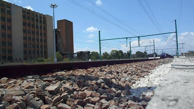 A freight train , owned by PIMK Rail crossing through railway station Pazardjik