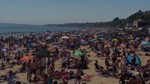 British Officials Threaten to Close Beaches After Thousands of People Flood the Sands Duri