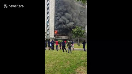 Fire and smoke engulf London tower block as residents watch on