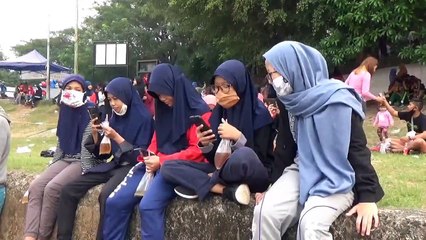 Residents flock to river filled with foam in Indonesia