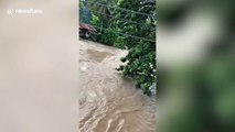 Flash floods swamp roads after heavy rain in night in the Philippines