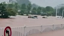 Chinese police officers break front windscreen to rescue motorist trapped in flooded car