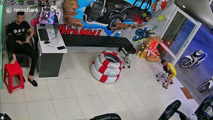 Boy, 4, spins himself round on barber's stool before stumbling into ornamental display