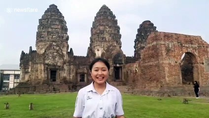 Monkeys steal schoolgirl's headband while she does presentation in Thailand