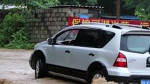 Firefighters rescue motorist after his vehicle gets trapped on flooded road in China