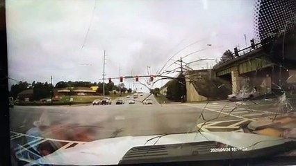 Truck Tips Over on to Cop Car