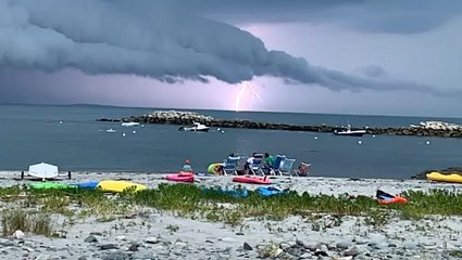 Slow-motion lightning striking under a shelf cloud