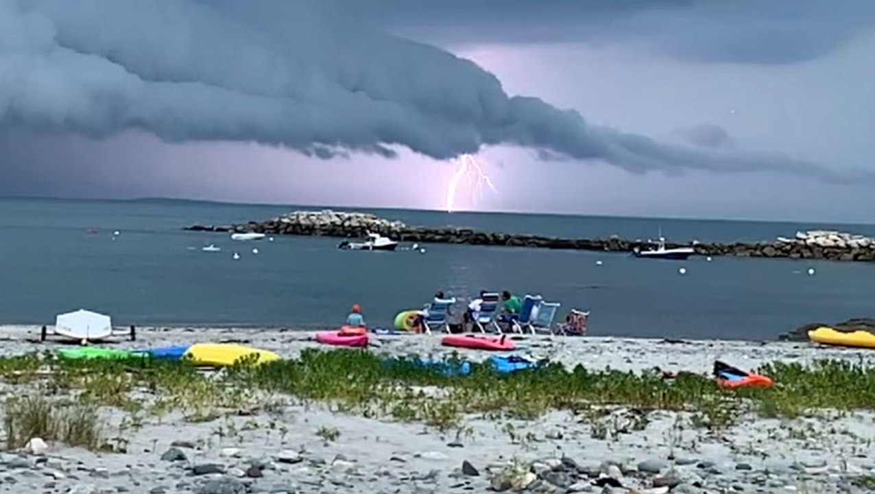 Slow-motion lightning striking under a shelf cloud