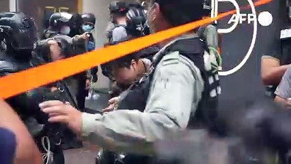 Hong Kong makes first security law arrests as thousands defy protest ban