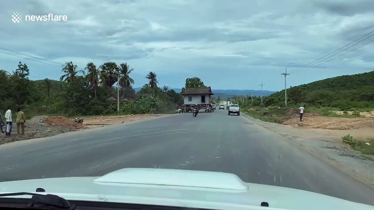 Cambodian family literally move house with help of tractors