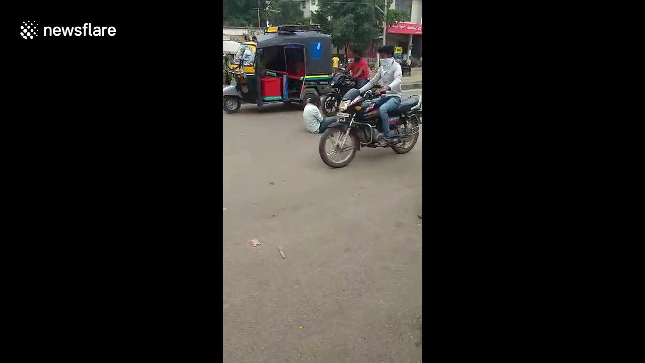 Two men drink in middle of road to overcome Corona worries