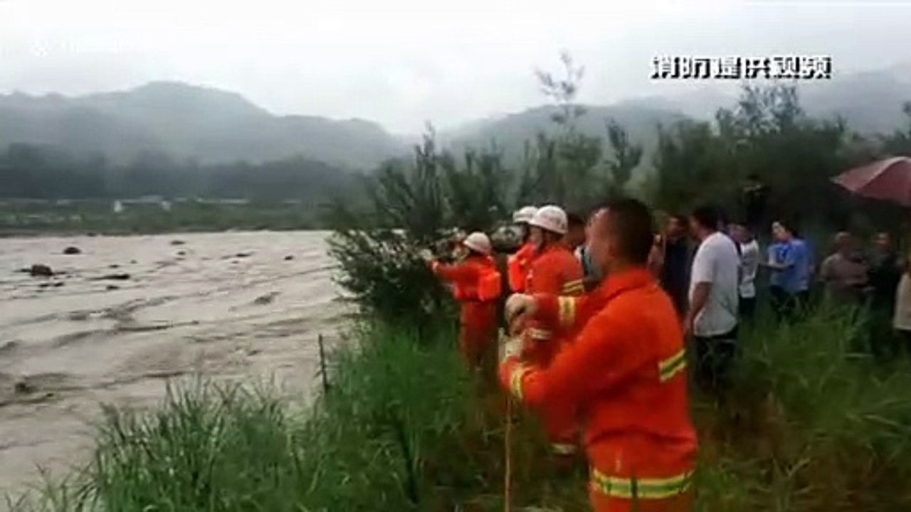 Firefighters in southern China rescue passengers after their car became trapped in flooded river