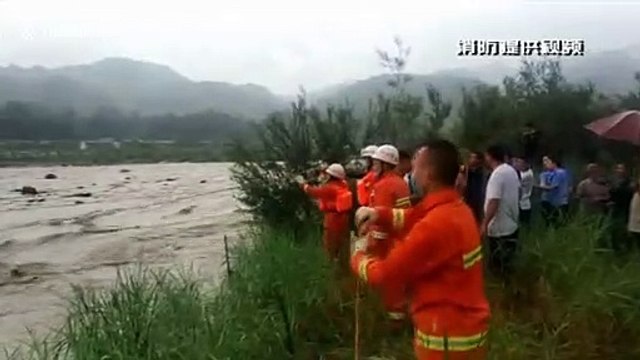 Firefighters in southern China rescue passengers after their car became trapped in flooded river