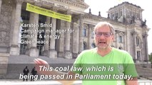 Angry climate activists hang giant banner on Reichstag