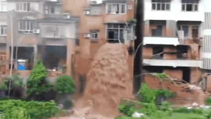 Floodwaters pour out of building from second floor