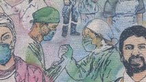 Artistas callejeros pintan un mural en Bruselas para honrar a los médicos